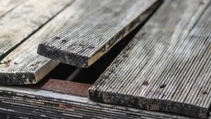 Inspect the deck boards for any loose boards or nails