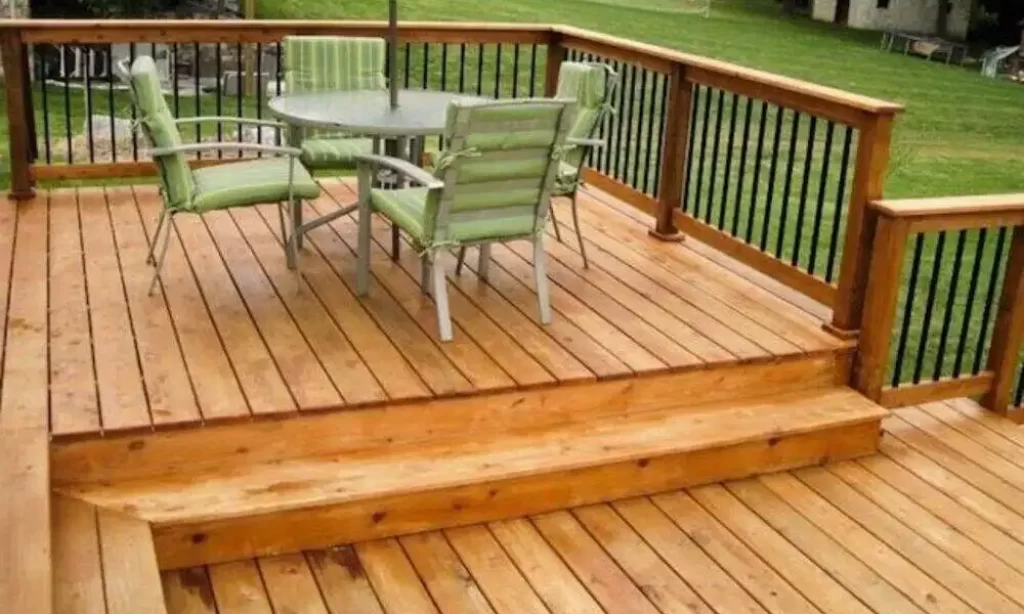 Natural cedar deck with a red brick house