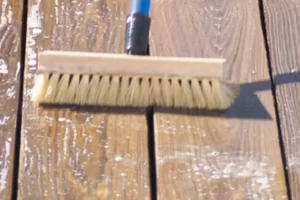 Stain the deck boards using a bristle brush