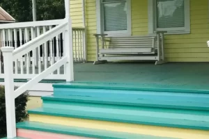 Yellow house with a multi-colored deck